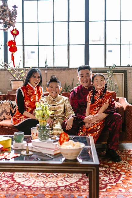 Family enjoying Chinese New Year celebration indoors with traditional clothing and decor.